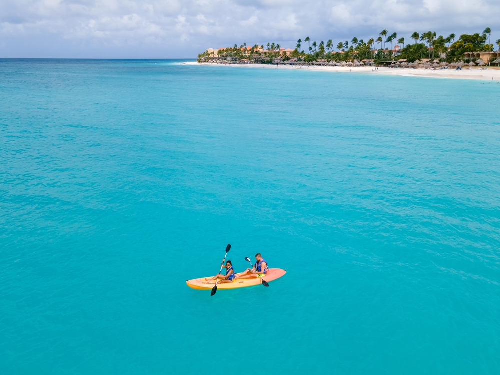 People paddleboarding during an eco-friendly vacation in Aruba
