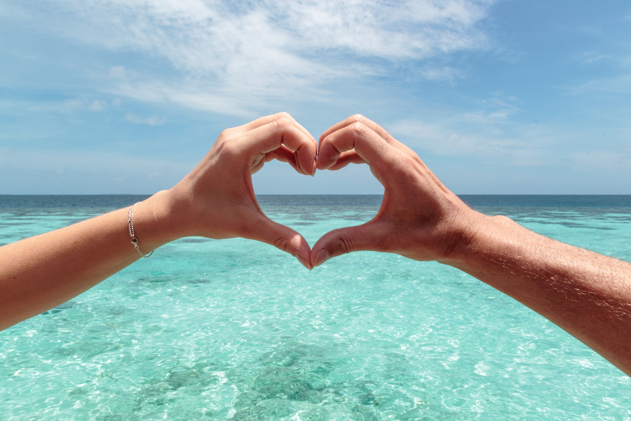 Hand-hearts-blue-water